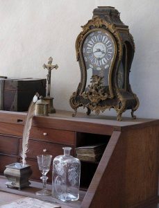 antique clock and other items on desk