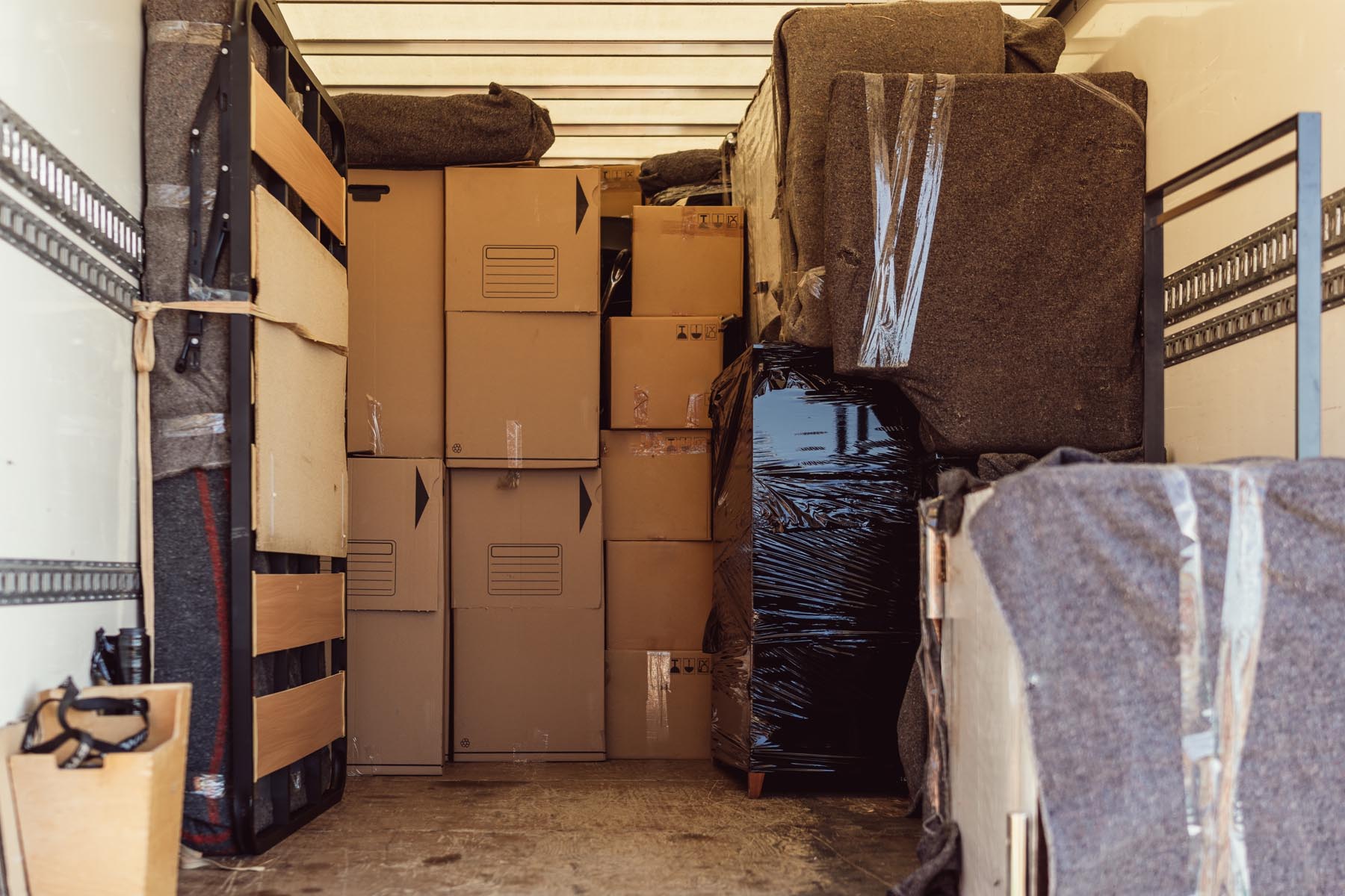 Full shot of a lot of boxes and packages from a move inside a truck